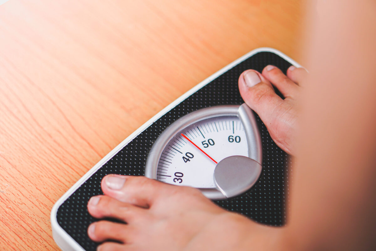 Close-up of feet on a scale representing weight monitoring during Semaglutide treatment