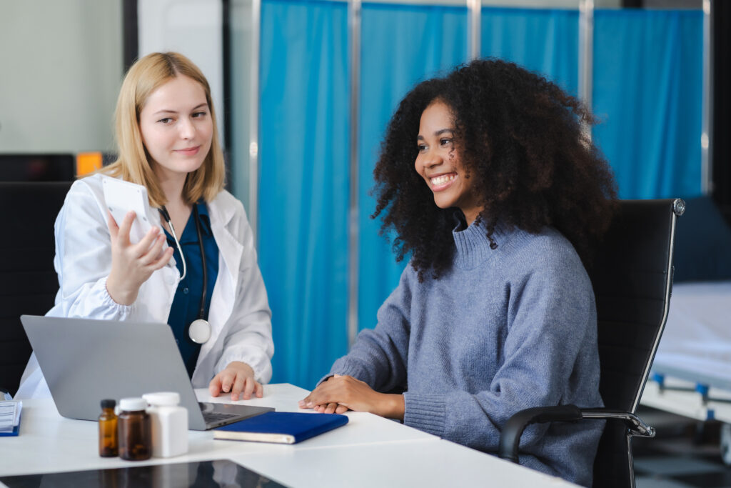 Happy patient and Doctor looking at savings from Direct Primary Care with FitRX