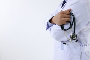 Doctor holding stethoscope representing the 7 pillars of optimal health, functional health approach, root cause medicine, and long-term health optimization