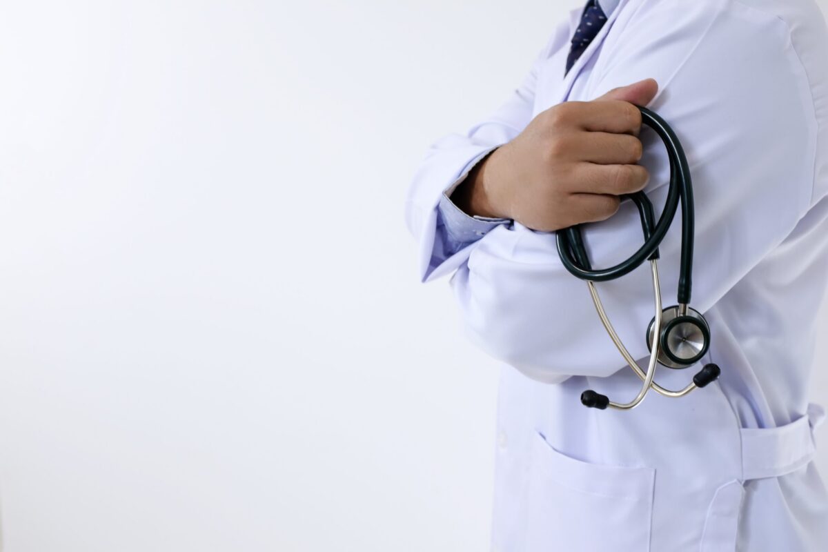 Doctor holding stethoscope representing the 7 pillars of optimal health, functional health approach, root cause medicine, and long-term health optimization