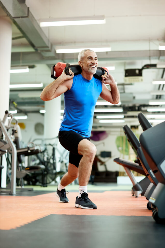Older man performing weighted lunges as exercise for healthy aging and resistance training after 40 to maintain strength and mobility.