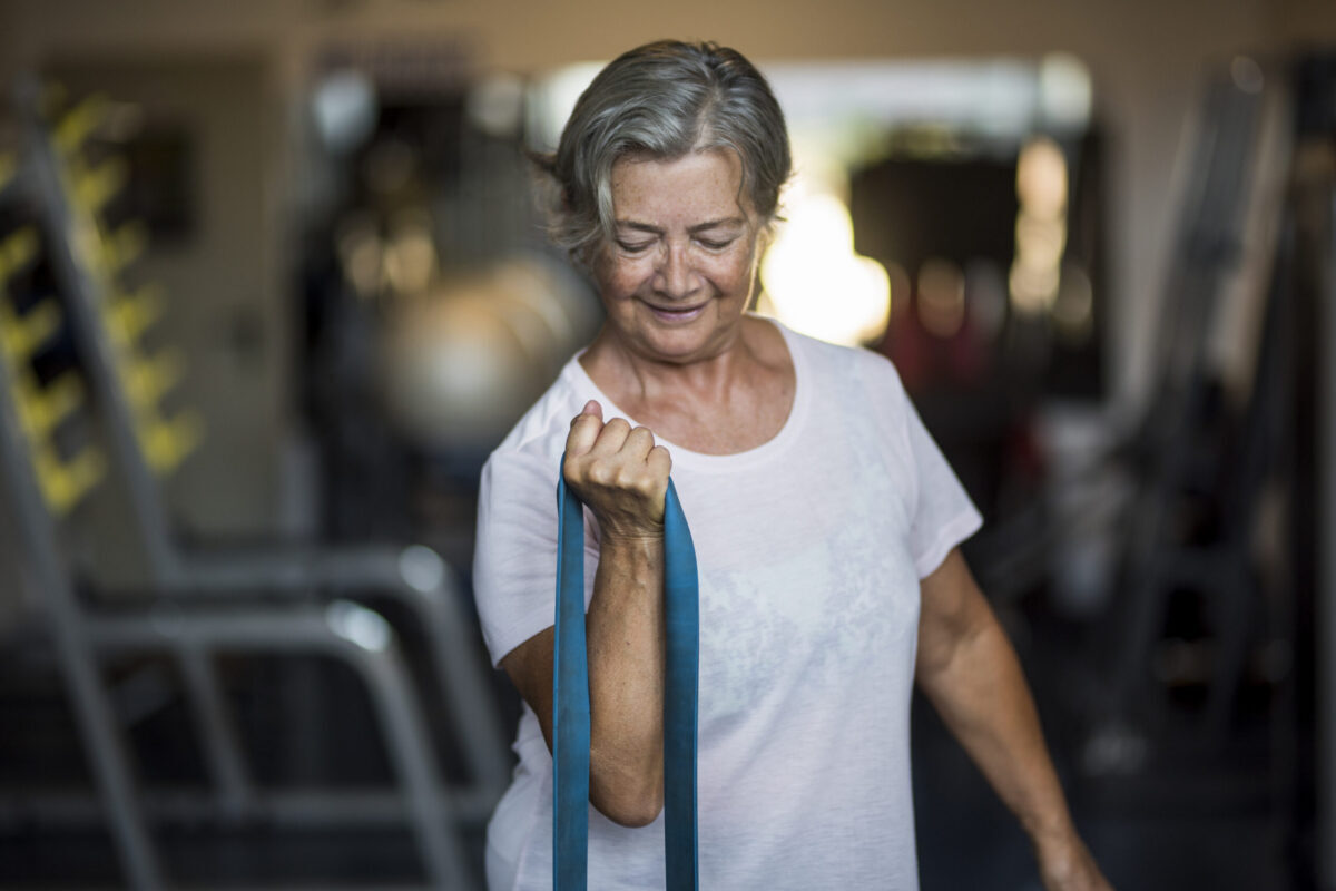 Woman using resistance bands for exercise for healthy aging and resistance training after 40 to support strength and mobility.